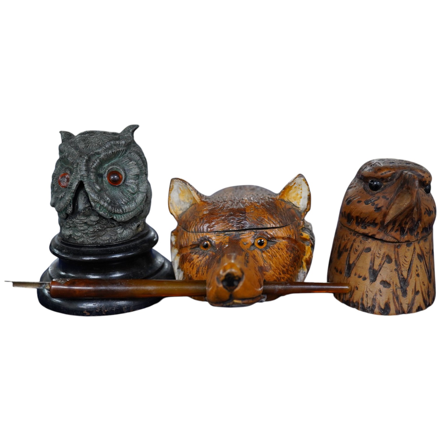 Two carved wood novelty inkwells in the form of animals, one with pen, together with a lead owl inkwell, largest 9cm high. Condition - fair